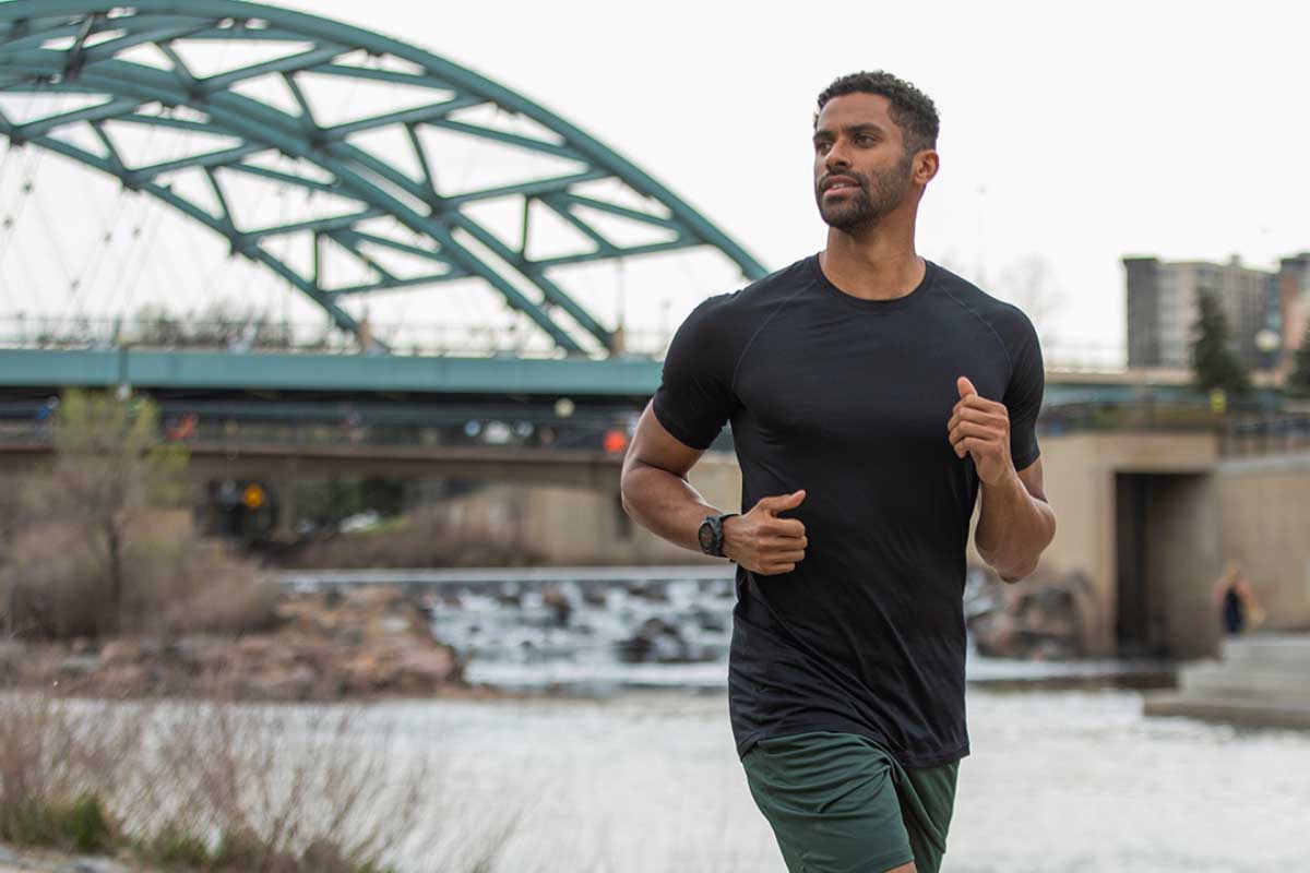 Man running with a bridge on the background
