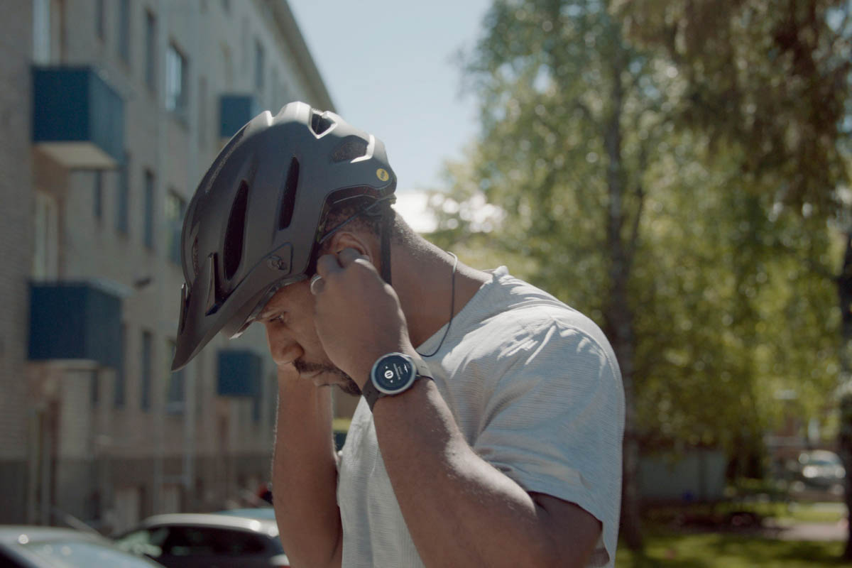 Man putting on a helmet